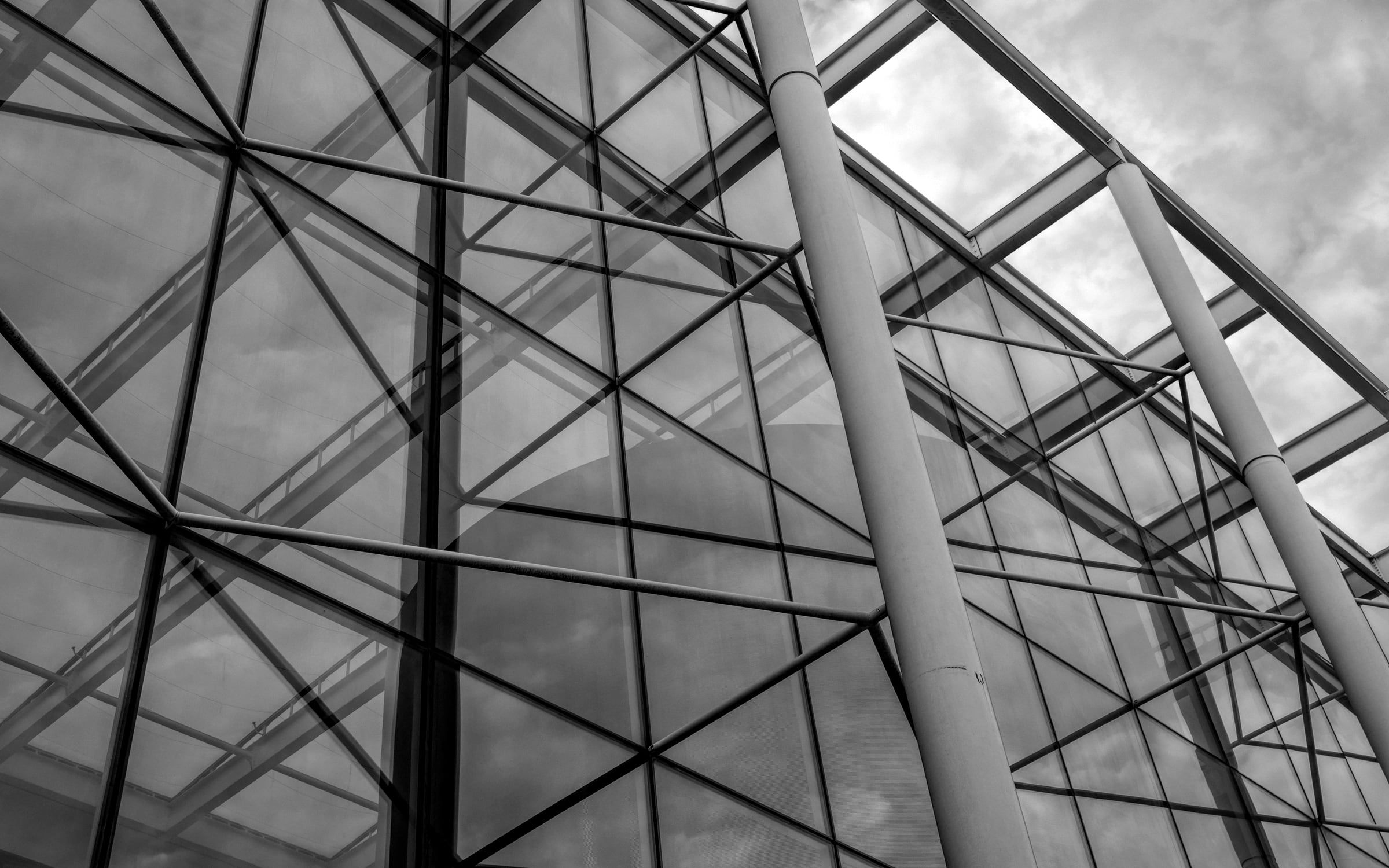 A geometric glass and steel canopy seen from below.